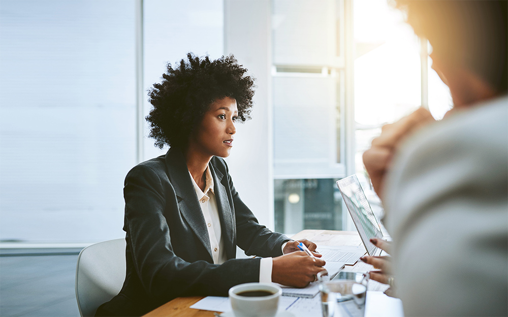 she can sell any idea. a group of businesspeople having a meeting in an office.